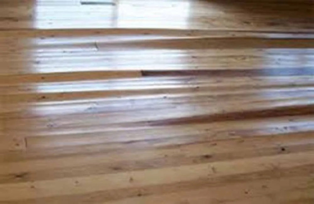 Real water damage on hardwood flooring in Sun City Summerlin Las Vegas caused by a leak.