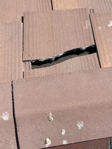 Broken roof tile on a residential tile roof causing water intrusion and potential interior water damage in Henderson, Nevada.